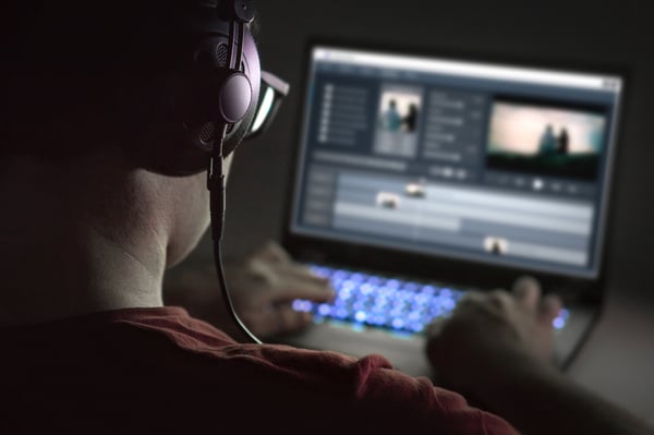 Man-editing-a-music-for-a-video-on-his-laptop