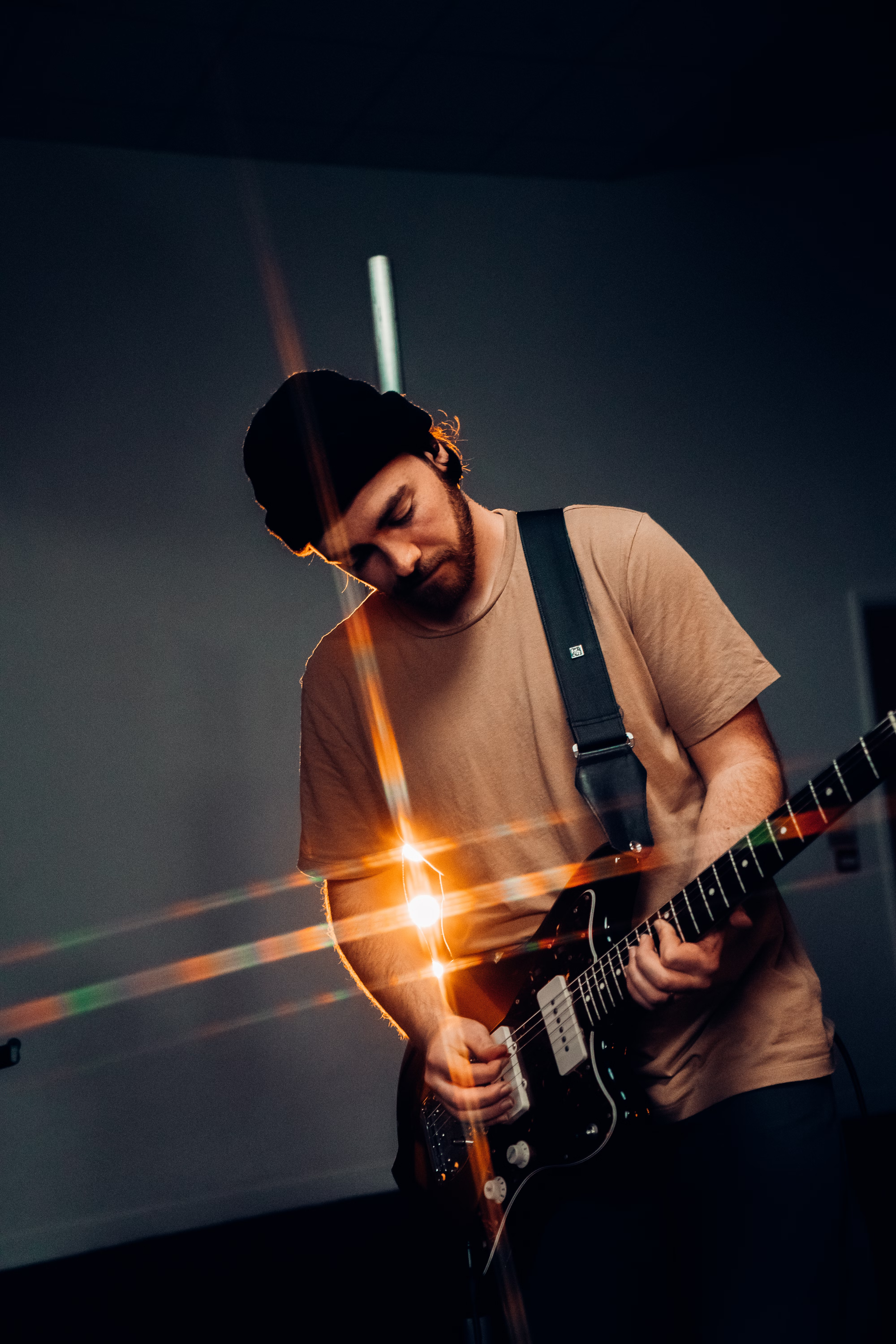 Man playing guitar, recording music for the Soundstripe enterprise plan